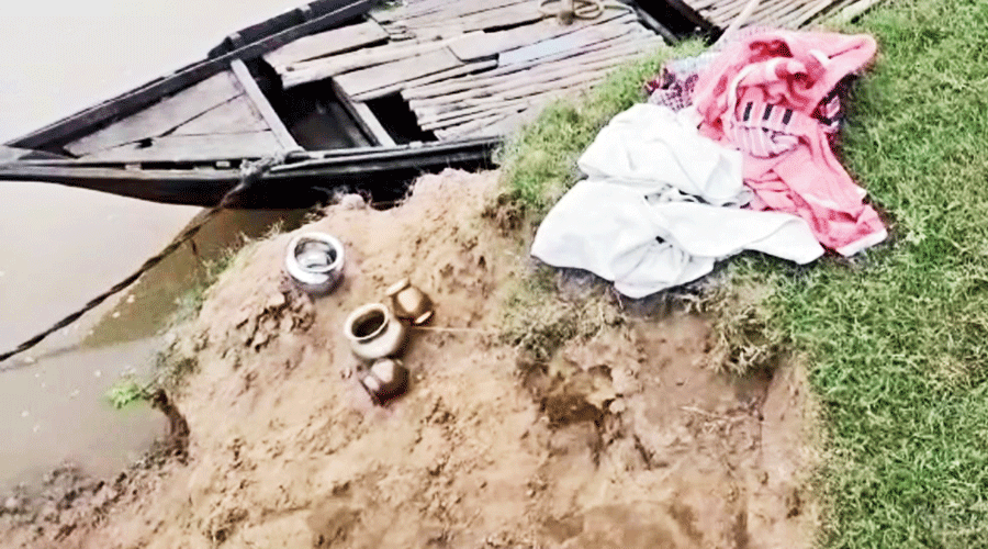 Utensils of the four youths lying on the bank of the Damodar in West Burdwan’s Andal on Monday.