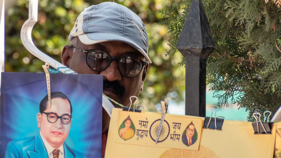  A man selling pictures of Dr. Babasaheb Ambedkar and Buddhist art outside the pilgrimage site of Deekshabhoomi, Nagpur, Maharashtra.