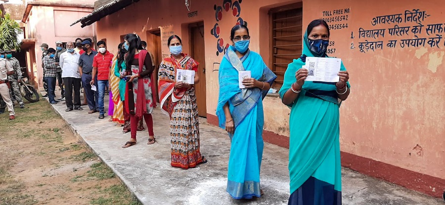 Voters wait in queue to cast their vote at a polling booth in Dumka on Tuesday.