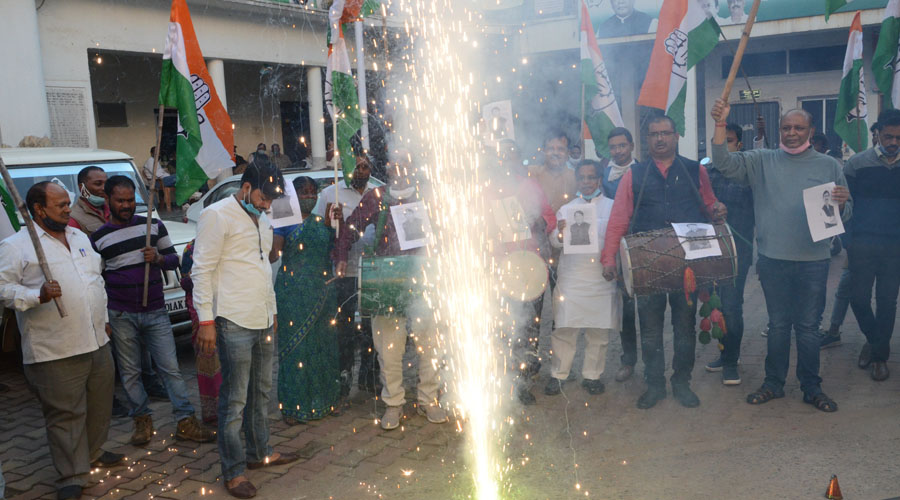 Congress workers burst crackers at the party office in Ranchi on Tuesday.