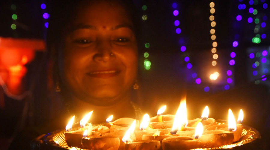 A lady with Diyas in Dhanbad on the occasion of Diwali evening on Saturday.