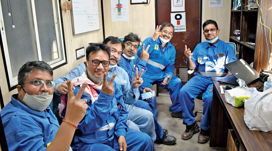 Members of the Oil India team show the victory sign after killing the Baghjan well on Sunday.