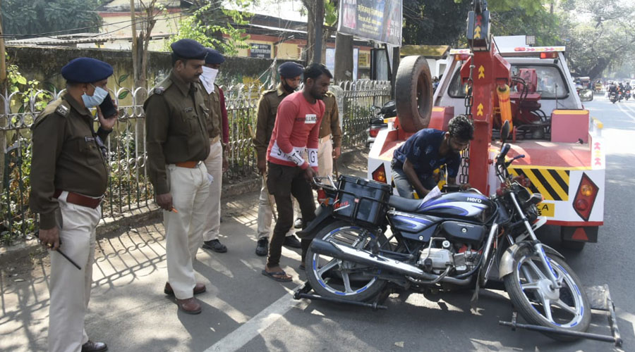 Traffic police seizing a motorbike during the anti-encroachment drive at Court Road in Dhanbad on Tuesday.