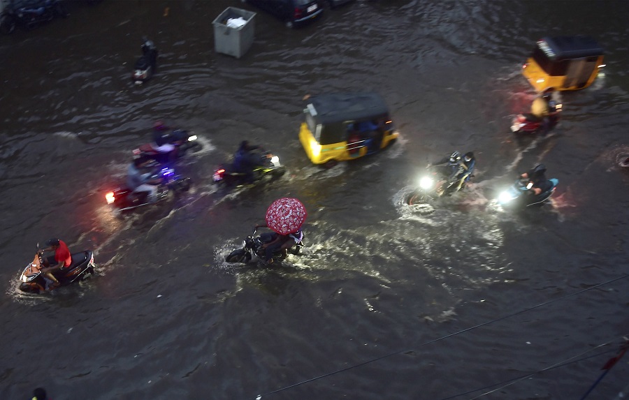 Vehicles ply on a waterlogged road during heavy rain triggered by Cyclone Nivar, in Chennai on Tuesday.