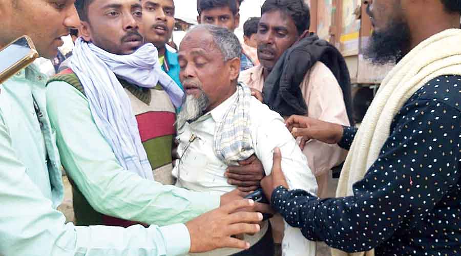 Trinamul leaders console the father of the youth whose body was found in the Ganga, at Manikchak in Malda on Wednesday