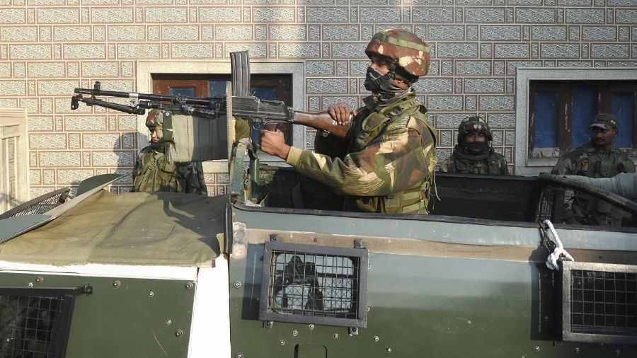 An Army personnel stands guard following the attack at Khushipora in the Parimpora area.