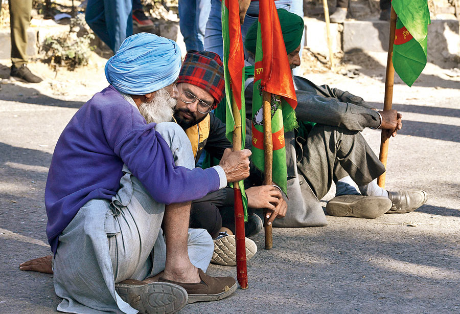 Farmers wait at the Singhu border.