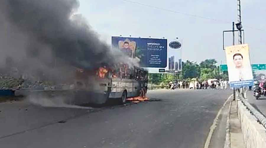 The bus on fire on VIP Road, near Kestopur, after the accident on Friday morning