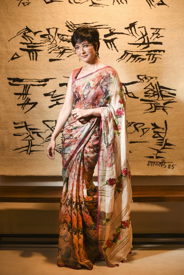 Arpita cuts a picture of cool comfort in this Abhishek Dutta handwoven linen sari with digital floral and geometric print. The pallu, with hand-embroidered bold flower motifs, lends a touch of contrast to the busy print on the body. Traditional Rajasthani earrings complete the look.  (Sari: Rs 11,500, Earrings: Rs 4,950)   “This sari is easy to drape and very comfortable too. It is ideal for the season since Pujas in Calcutta can be really hot and humid. You can wear it for anjali or as an evening outdoor do. Instead of a blouse, you can wear it with a shrug or jacket,” said Dutta.