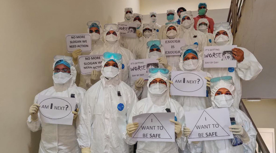 Medics wearing PPE suits stage a silent demonstration demanding justice for the Hathras victim, at AIIMS, in Patna, Thursday, Oct 1, 2020. 
