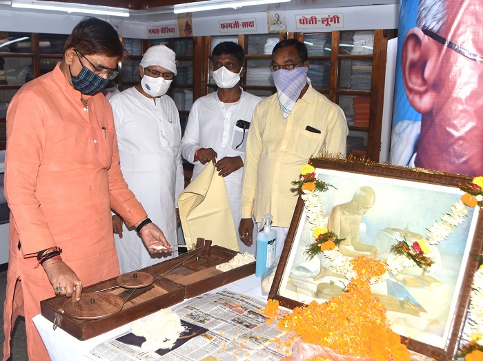 Dhanbad MLA, Raj Sinha spinning the charkha at Khadi Graminudyog Bhandar at Court More in Dhanbad on Friday