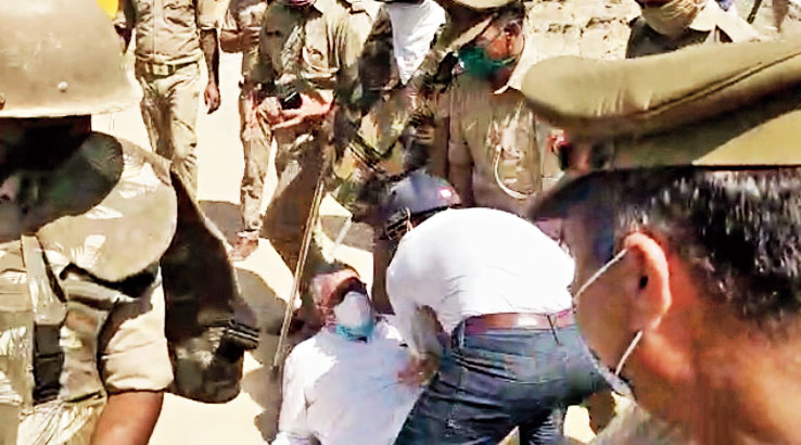 Trinamul MP Derek O’Brien falls after being pushed by an official outside the victim’s village in Hathras, Uttar Pradesh.