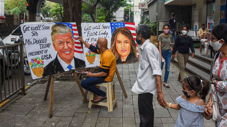 A Gurukul teacher makes a painting of US President Donald Trump and USs First Lady Melania Trump after they tested positive for COVID-19, at Lalbaug in Mumbai, Friday, Oct. 2, 2020. 