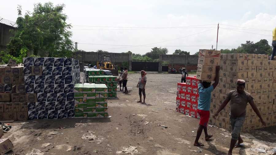 Cartons containing can beer being carried to be destroyed on the premises of JSBCL preemies at Bhilaipahadi near Jamshedpur on Wednesday.