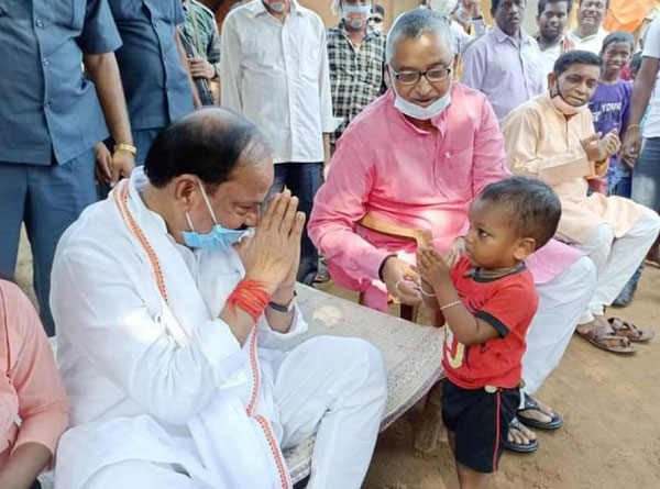 Raghubar Das being greeted by a tribal kid in Dumka during BJP's Mahila Jan Choupal programme on Saturday. 