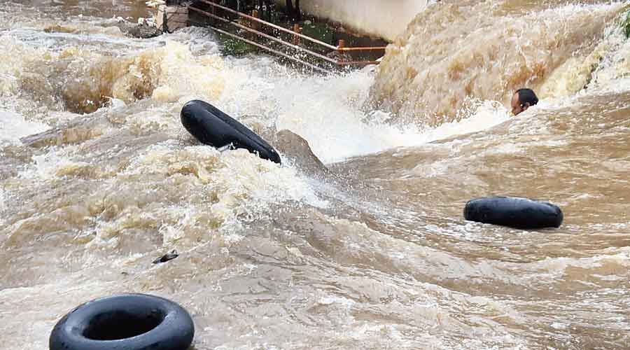 A man struggles to stay afloat in gushing floodwaters