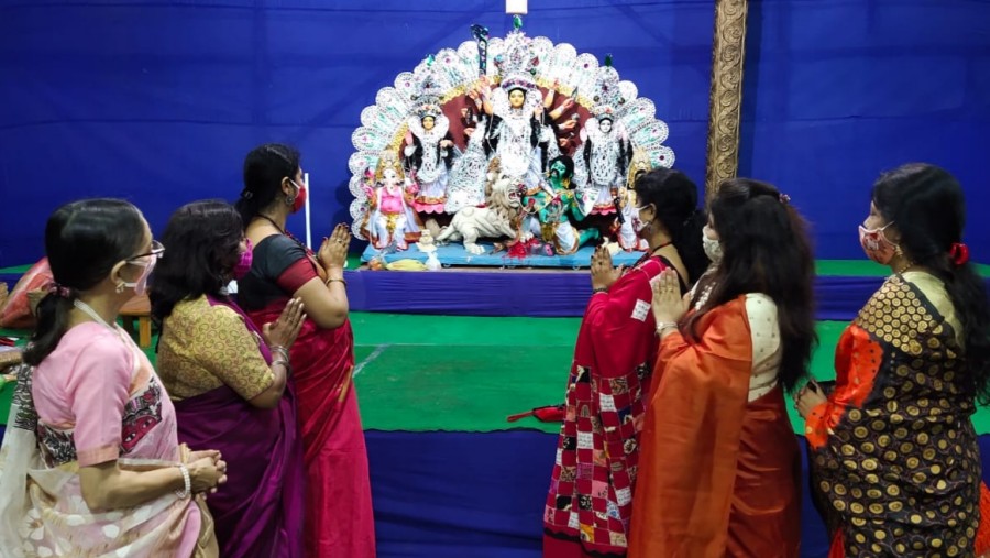 Devotees offer prayers at the puja pandal on the Bengali Kalyan Samiti Zila Parishad campus in Dhanbad on Thursday.