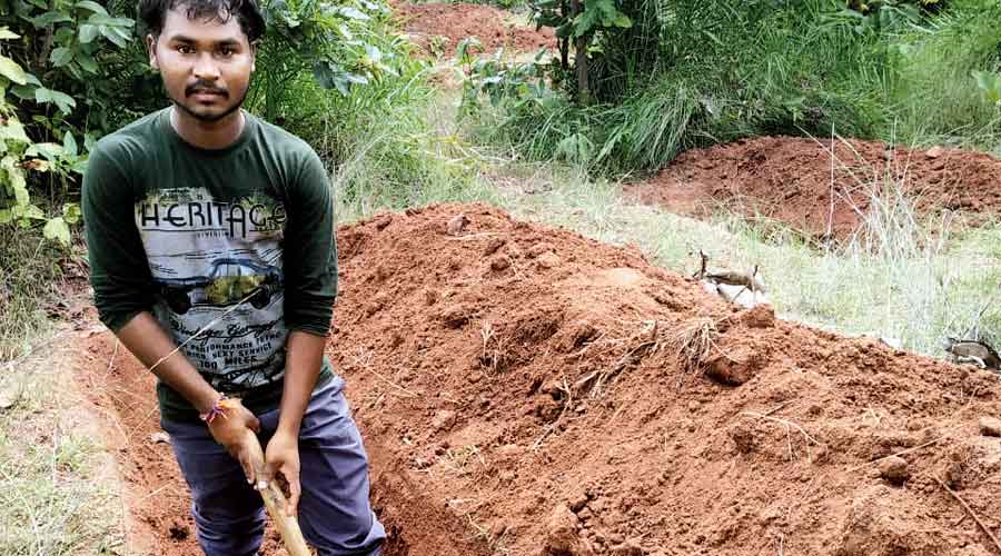 Ananta Beria digging a  canal