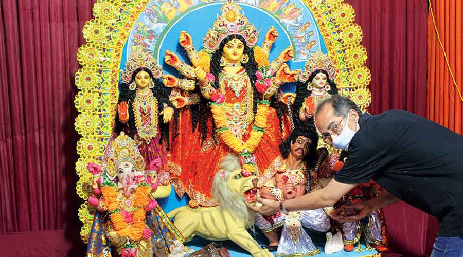 A member of CJ Block’s Das Chowdhury family inspects the idols
