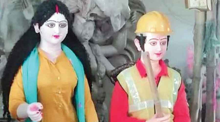 Goddess Durga and her children depict frontline workers at the Adarsha Sangha pandal in Islampur. 