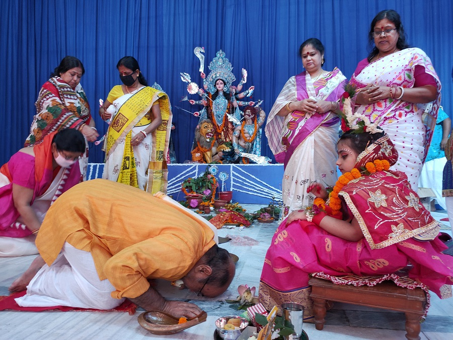 Devotees seeking blessings after the Kumari Puja at Deshpriya Club..