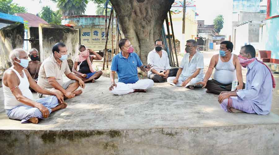Ghosh family members discuss arrangements on the family temple premises at Marrah village in Bokaro on Tuesday