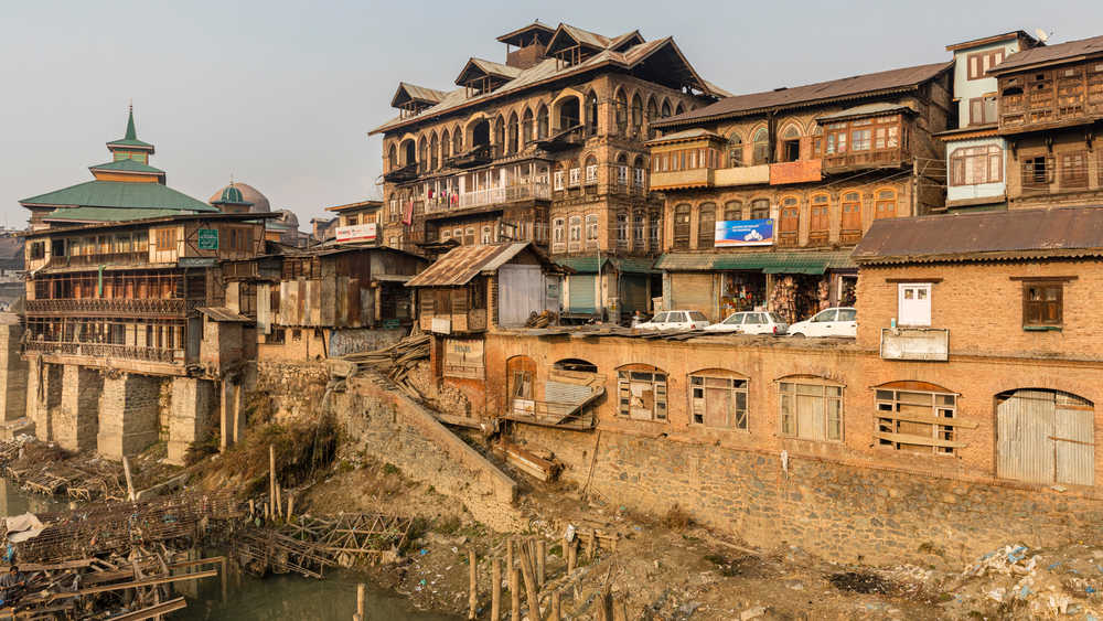 View of old historic houses on the banks of the river Jhelum in the town of Srinagar in Kashmir.