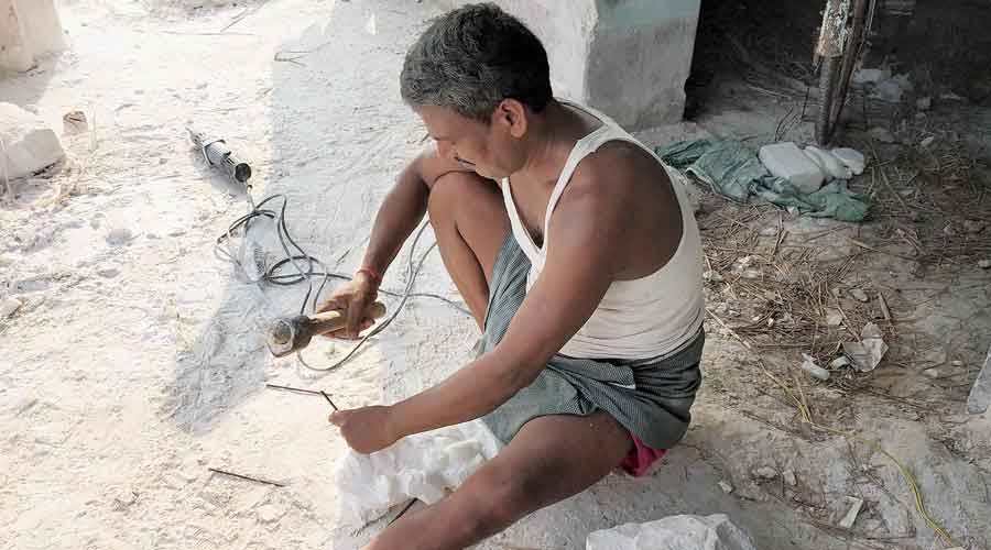 A sculptor carves an idol