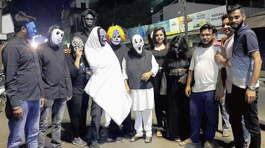 Halloween revellers in masks and costumes in Raiganj on Friday night. 