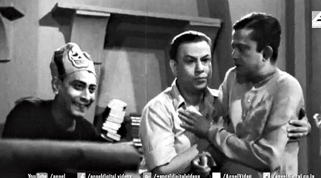 12. Bhanu Bandyopadhyay’s comedy act was often supported by some brilliant actors, most famous among them being Jahar Roy. However, in this scene we can see two other actors who also belonged to the gang of laugh rioters. Identify them.