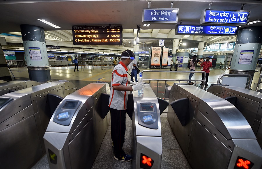 A worker sanitises entry gates at Rajiv Chowk station in New Delhi on Monday.