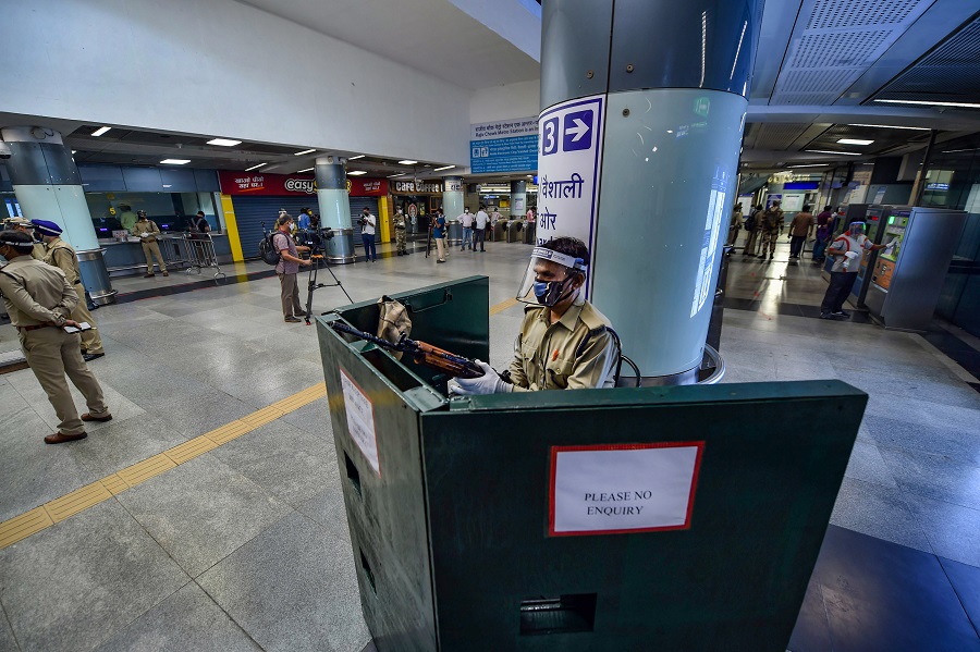 A security personnel checks his gun at Rajiv Chowk station in New Delhi on Monday.