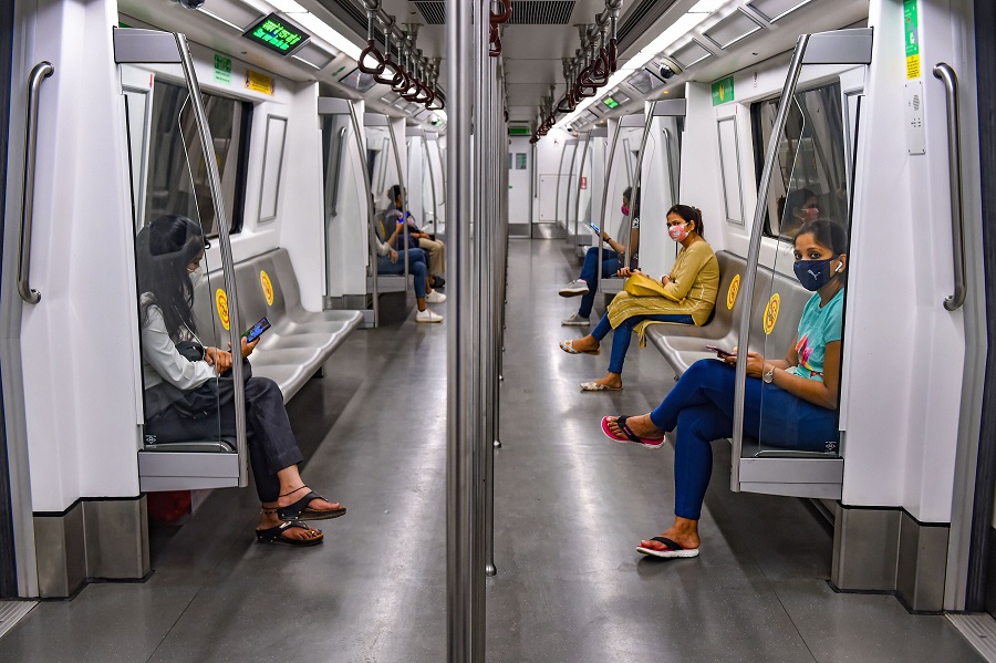 Commuters travel in a metro train in New Delhi on Monday.