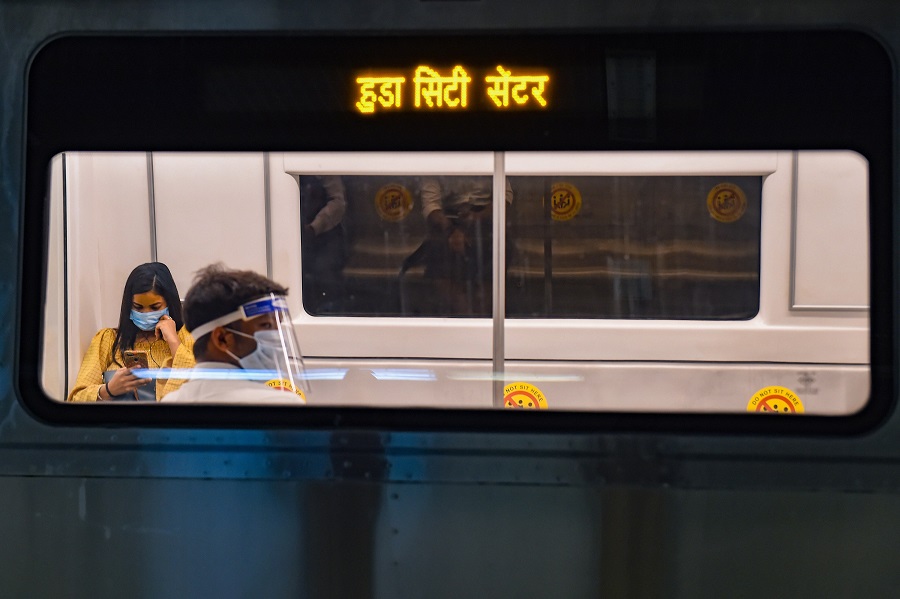 Commuters maintain social distancing in a metro in New Delhi on Monday.
