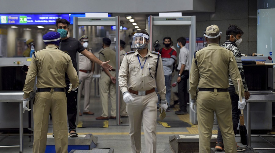 A commuter undergoes checking as security personnel patrol Rajiv Chowk station in New Delhi on Monday.