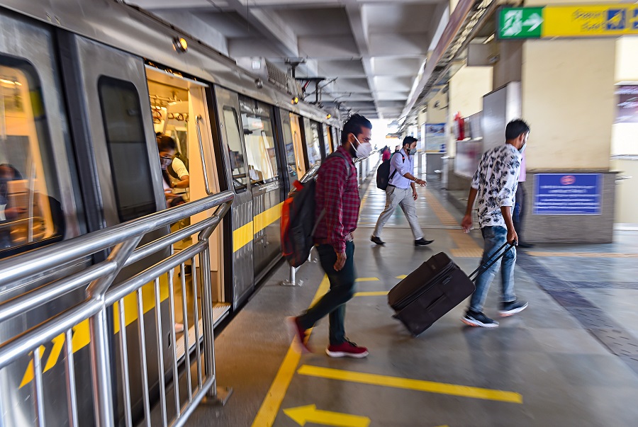 Commuters deboard a metro train at at HUDA City Centre station in New Delhi on Monday.