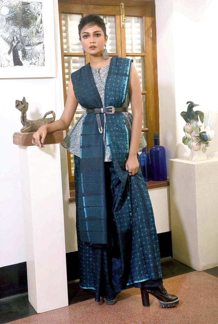 Look 3: Bangalore pure silk Shibori tie-dye sari Shibori is a form of tie-dye that originated in Japan but has developed into a niche craft in India. Here the fabric has been folded into panels and painstakingly stitched together before it is put into dye. The pattern reveals itself once the dyeing process is complete and the stitches are removed. The colour on the sari is as per the panels they were in and the panels closest to the dye are therefore deeper than those folded inside. This is a two-toned sari having been dyed once with a lighter shade, before stitching, which gives it greater depth. The look is accessorised with a short cropped top made in handwoven khadi cotton. It is hand block-printed near Calcutta using hand-cut antique blocks. The dyes used contain natural indigo and raisin.