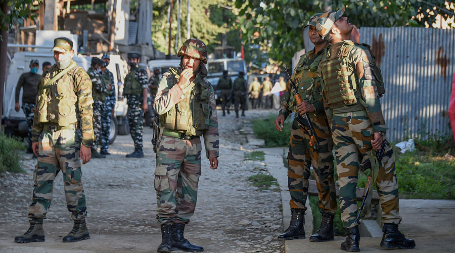 Security forces during an encounter with militants at Kawoosa area of the Central Kashmir on Monday.