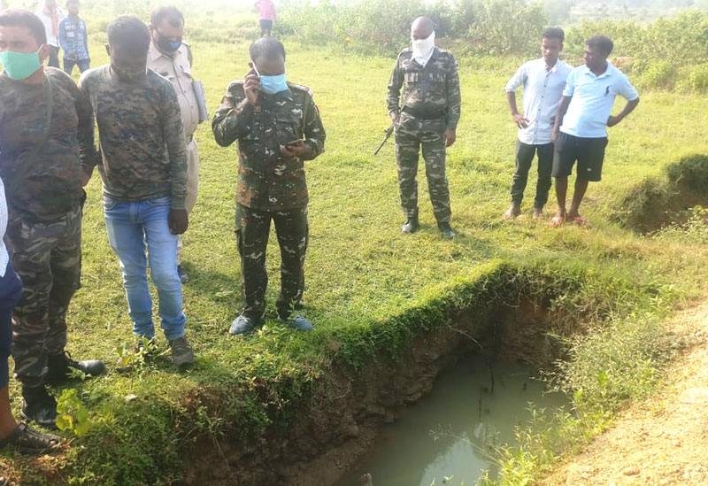 Police inspecting the pit where Bunty Rai’s dead body was found behind the Chaita School in Topchanchi block.