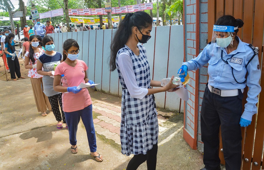 Students sanitize their hands outside an examination centre before appearing for the National Eligibility Cum Entrance Test (NEET) during unlock 4.0, in Ranchi, Sunday, Sept. 13, 2020.