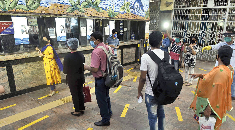 Candidates maintain safe distance among themselves while waiting to buy tickets