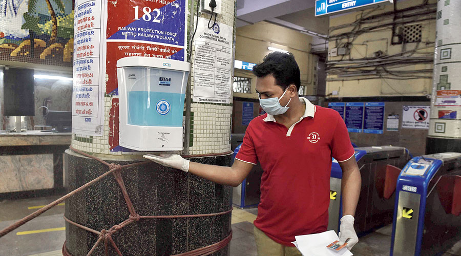 A candidate takes sanitiser from a dispenser at the station