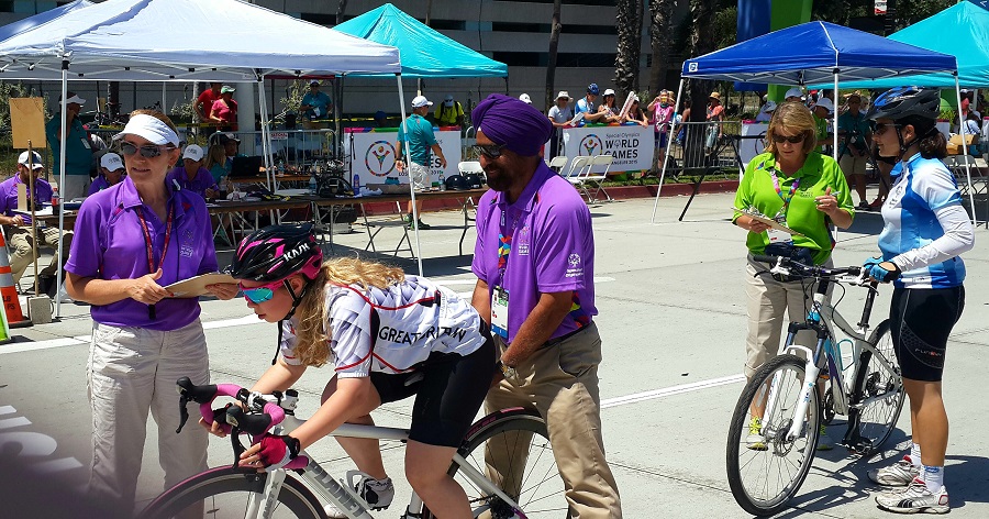 Avtar Singh helps a cyclist during an international Special Olympics competition.