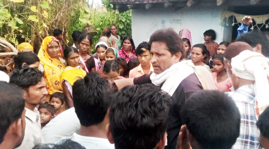 A policeman gathers details from villagers on Friday