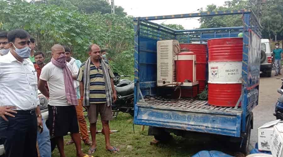 Illegal lubricant drums and machines being seized.
