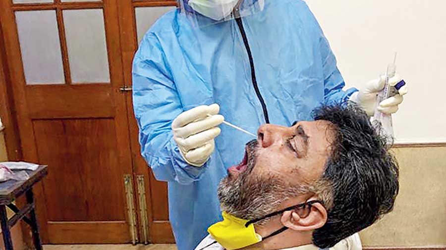A medic collects a sample from Congress leader DK Shivakumar in Bangalore on Saturday. 