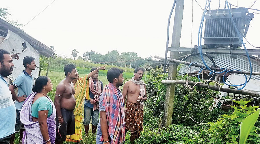 Muragachha Baishnav Para villagers point to the damaged transformer. 