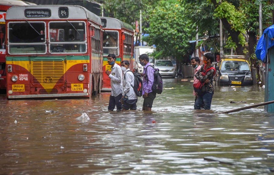 People wade through a waterlogged street at Lalbaug-Parel are in Mumbai on Wednesday.