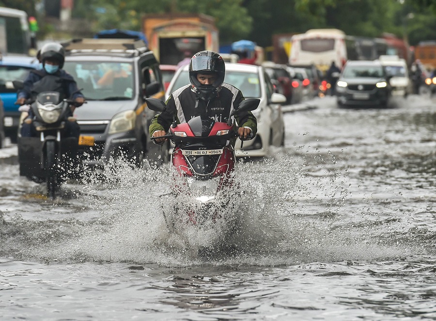 Vehicles move on a waterlogged street at Wadala in Mumbai on Wednesday.