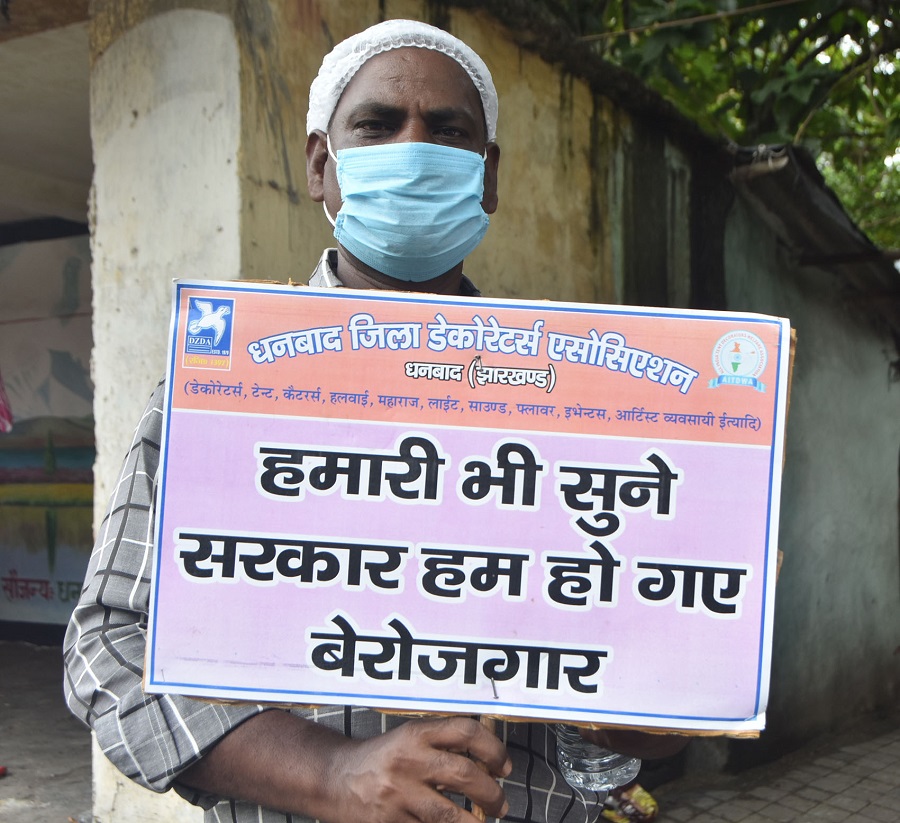 A protester holds up a banner highlighting his state of unemployment in Dhanbad on Wednesday
